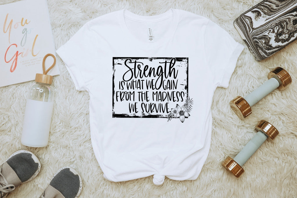 Strength Is What We Gain” Motivational Quote T-Shirt – Uplifting Graphic Tee for Women