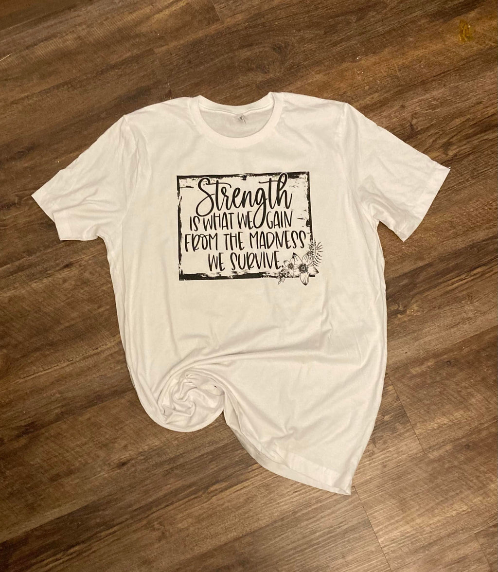 Strength Is What We Gain” Motivational Quote T-Shirt – Uplifting Graphic Tee for Women