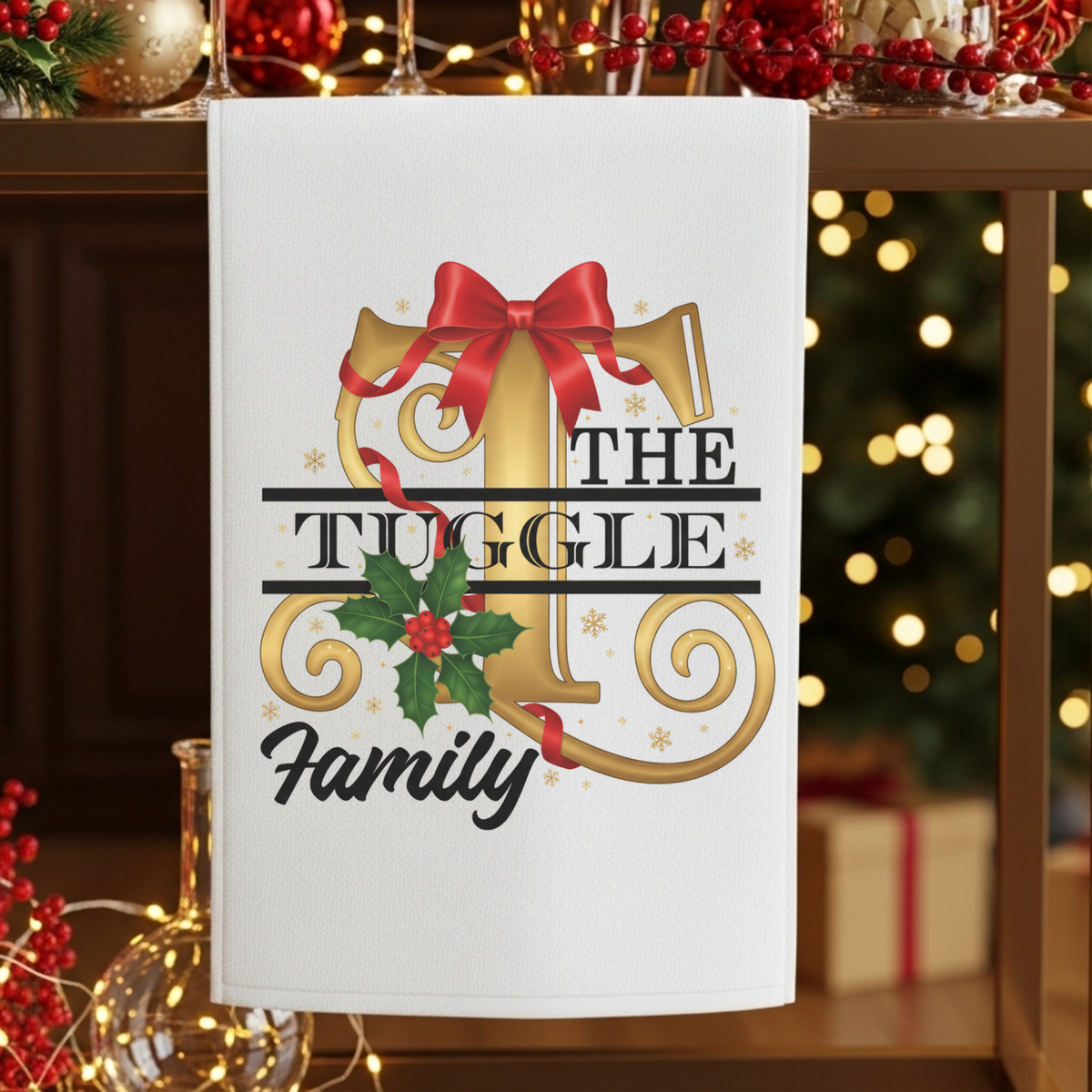 Decorative towel with 'The Tuggle Family' design on a festive background with lights and decorations.
