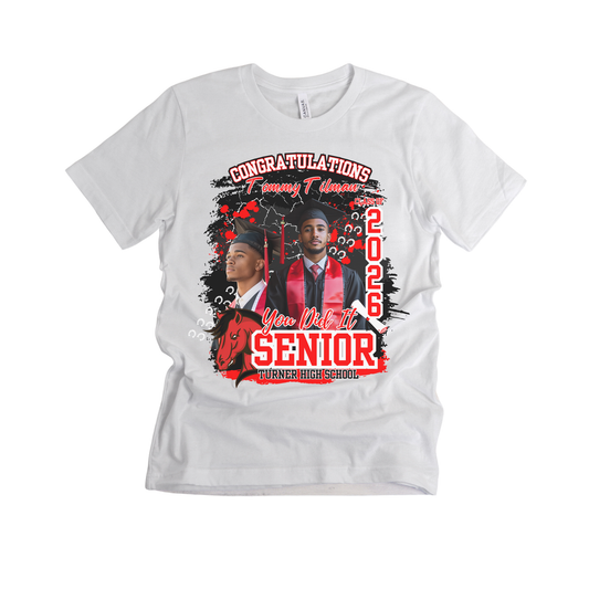 White t-shirt with graduation-themed design featuring two students and text on a white background